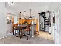 Inviting living space featuring a cozy breakfast bar, spiral staircase, and seamless flow into the kitchen area at 20100 N 78Th Pl # 2193, Scottsdale, AZ 85255