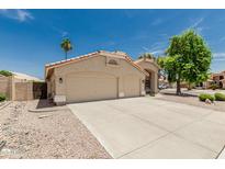 Beautiful exterior showcasing a spacious three-car garage, and well-maintained landscaping at 20961 N 96Th Dr, Peoria, AZ 85382