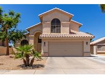 Charming two-story home featuring a well-manicured front yard, covered entryway, and attached two-car garage at 2438 S Chestnut Pl, Chandler, AZ 85286