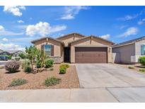Charming single-story home featuring a two-car garage, desert landscaping, and a stone facade at 2898 E Kim Dr, San Tan Valley, AZ 85143