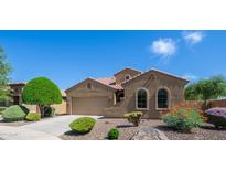 Charming single-story home featuring arched windows, a two-car garage, and well-maintained desert landscaping at 3994 E Grand Canyon Pl, Chandler, AZ 85249
