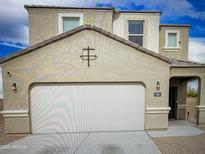 Charming two-story home featuring a two-car garage and stucco exterior with decorative accents at 4061 N 308Th Ln, Buckeye, AZ 85396