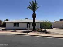 Charming single-story home featuring a well-manicured yard and a desert landscaped front yard at 4347 E Catalina Cir, Mesa, AZ 85206