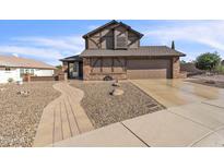 Two-story home boasts a manicured rock yard and a two car garage at 4547 E Buist Ave, Phoenix, AZ 85044