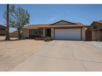 Charming single-story home featuring a two-car garage and low-maintenance desert landscaping in front yard at 4623 W Solano S Dr # South, Glendale, AZ 85301