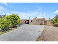 Charming single-story home featuring a spacious driveway, attached garage, and mature landscaping at 4632 W Marlette Ave, Glendale, AZ 85301