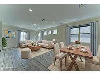 Open-concept living area with stylish furnishings and plenty of natural light from multiple windows at 4927 S Tune --, Mesa, AZ 85212