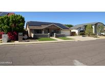 Charming single-story home with solar panels, fresh lawn, and inviting curb appeal at 6352 W Campo Bello Dr, Glendale, AZ 85308