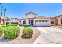 Charming single-story home with a well-manicured front yard, a two-car garage, and a tile roof at 925 W San Marcos Dr, Chandler, AZ 85225