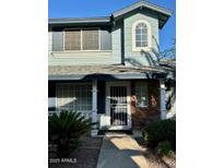 Charming home featuring a covered front door entry, a window, and a well-maintained exterior at 10101 N 91St Ave # 88, Peoria, AZ 85345