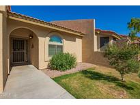 Charming home featuring an arched entryway and complemented by a well-maintained yard at 1021 S Greenfield Rd # 1165, Mesa, AZ 85206