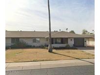 Charming single-story home featuring a well-maintained front yard and an attached garage and a neutral color scheme at 11135 W Cameo Dr, Sun City, AZ 85351