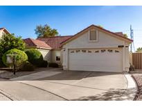 Attractive single-story home featuring a two-car garage, desert landscaping, and a warm, inviting exterior at 1201 E Campbell Ave, Gilbert, AZ 85234