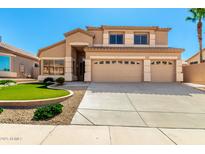 Charming two-story home with a three car garage, a manicured lawn and desert landscaping at 15229 S 18Th Dr, Phoenix, AZ 85045
