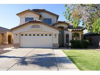 Charming two-story home with a well-manicured lawn and a two-car garage at 1750 E Erie St, Gilbert, AZ 85295