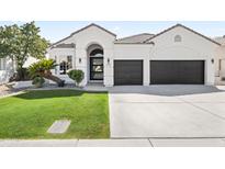Charming single-story home features a two-car garage, arched entryway, and well-manicured lawn at 21480 N 56Th Ave, Glendale, AZ 85308