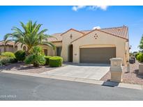 Charming single-story home featuring desert landscaping, a tile roof, and a two-car garage at 2163 N 164Th Dr, Goodyear, AZ 85395