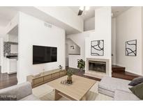 Bright living room with fireplace, flat screen tv, and modern furnishings in neutral color palette at 3633 N 3Rd Ave # 2031, Phoenix, AZ 85013