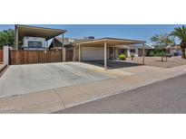 Charming single-story home with a long driveway, carport, and fenced in RV parking at 3802 W Kelton Ln, Phoenix, AZ 85053