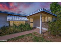 Charming single-story home featuring a covered porch, tidy landscaping, and an inviting entryway at 3944 E Oak St, Phoenix, AZ 85008