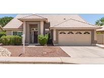 Charming single-story home with well-manicured landscaping and a two-car garage at 4137 E Stanford Ave, Gilbert, AZ 85234