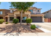 Inviting two-story home featuring a well-maintained front yard with desert landscaping and a spacious two-car garage at 44517 W Copper Trl, Maricopa, AZ 85139