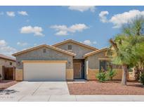 Charming single-story home with a two-car garage, desert landscaping, and a well-maintained lawn at 45391 W Portabello Rd, Maricopa, AZ 85139