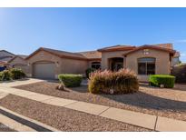Charming single-story home showcasing its desert landscaping, neutral color palette and welcoming curb appeal at 5314 W Bowker St, Laveen, AZ 85339