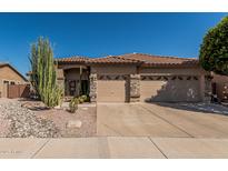 Charming single-story home featuring a well-kept landscape and three-car garage at 10413 E Emelita Ave, Mesa, AZ 85208