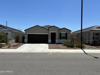 Charming single-story home with a two-car garage and well-maintained front yard at 18765 W Adams St, Buckeye, AZ 85326