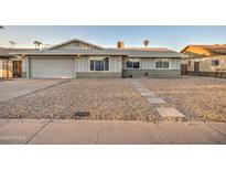 Charming single-story home featuring a spacious front yard with stone landscaping and a two-car garage at 2122 E Radcliffe Dr, Tempe, AZ 85283