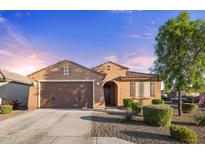 Charming single-story home features a well-manicured front yard and attached two-car garage at 25969 W Tina Ln, Buckeye, AZ 85396