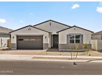 Charming single-story home featuring a two-car garage, desert landscaping and a neutral color palette at 4035 S 176Th Dr, Goodyear, AZ 85338