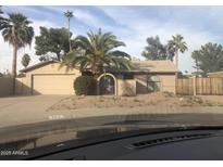 Charming single-story home with desert landscaping and mature palm trees in a sunny neighborhood at 4912 E Columbine Dr, Scottsdale, AZ 85254