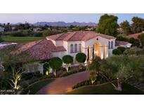 Stunning exterior view of a Spanish-style home with a red tile roof and landscaped grounds at 5610 E Sanna St, Paradise Valley, AZ 85253