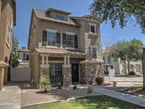 Charming two-story home with stone accents, covered porch, and well-maintained landscaping at 9233 E Neville Ave # 1011, Mesa, AZ 85209
