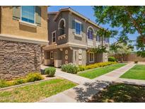 Attractive two-story townhome with a landscaped yard and inviting walkway at 9233 E Neville Ave # 1127, Mesa, AZ 85209