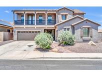 Two-story home featuring a balcony, well-manicured landscaping and a two car garage at 11952 W Villa Chula Ln, Sun City, AZ 85373