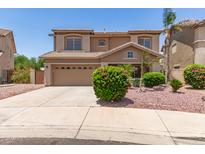 Two-story home featuring desert landscaping, tile roof, and a two-car garage at 12274 W Monroe St, Avondale, AZ 85323