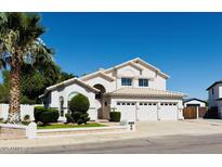 Charming two-story home with a three-car garage, a well-manicured lawn, and mature landscaping at 25015 N 50Th Ave, Phoenix, AZ 85083