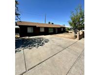 Charming single-story home featuring a large driveway and classic curb appeal at 3211 W Campbell Ave, Phoenix, AZ 85017