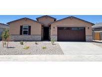 Charming single-story home with a well-maintained gravel front yard and a two-car garage at 37131 W Parador Ln, Maricopa, AZ 85138
