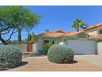 Charming single-story home featuring a two-car garage, vibrant landscaping, and a classic terracotta roof at 5902 E Juniper Ave, Scottsdale, AZ 85254