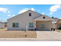 Inviting single-story home with a neutral color scheme, covered entryway, and low-maintenance landscaping at 9471 W Magnum Dr, Arizona City, AZ 85123