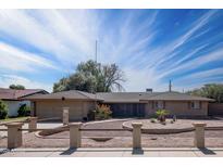 Ranch style home with manicured front yard and low brick fence at 1158 N Barkley St, Mesa, AZ 85203