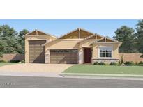 Beautiful single-story home featuring a tan facade, a two-car garage, and a well-manicured front yard at 25576 N 174Th Dr, Surprise, AZ 85387
