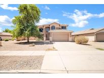 Two-story home featuring a neutral palette, tile roof, two car garage and a desert landscape at 2605 W Darrel Rd, Phoenix, AZ 85041