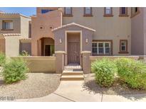 Charming townhome facade with private gated entry and landscaped front yard at 3935 E Rough Rider Rd # 1101, Phoenix, AZ 85050
