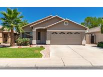 Charming single-story home with desert landscaping, a two-car garage, and a well-maintained lawn at 3940 E Heather Ct, Gilbert, AZ 85234