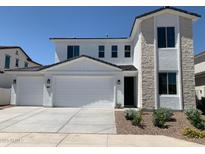 Charming two-story home featuring a three-car garage, stone facade, and well-maintained landscaping at 4924 W Brown St, Glendale, AZ 85302